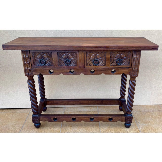 20th-century console table with slab top on a frieze with two drawer fronts decorated with carved and incised floral...