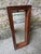 Vintage narrow rectangular wall hung mirror. This small scale wooden mirror has hardware on the back that allows you to...