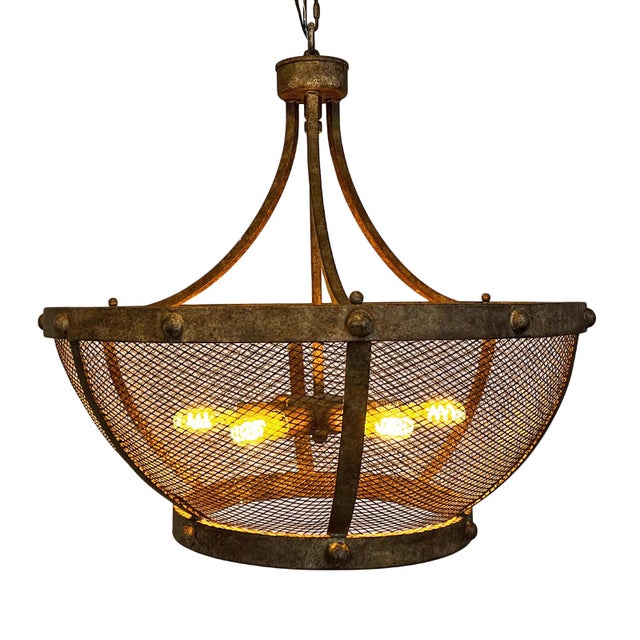 Aged iron chandelier defined by its hand-finished patina and airy mesh basket form, striking a balance between industrial...