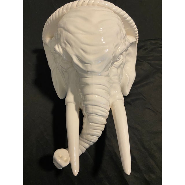 Large mid-century elephant head design in glazed white ceramic pottery. Flat platform top for display use. Hand painted....