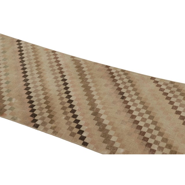 This vintage rug is a 3x8 Turkish distressed piece, made with hand-knotted wool circa mid-20th century. It is an exciting...