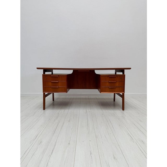 Elegant model 75 desk, designed by gunni omann for omann jun in denmark during the 1960s. crafted in teak, the desk...