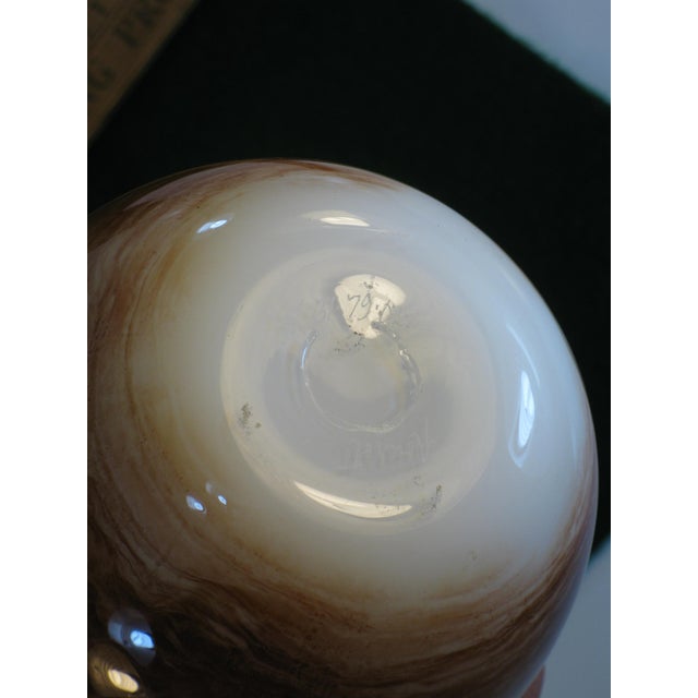 The Art Glass Vase by Michael Nourtot is a vintage piece crafted in the United States during the 1970s. With its cased...