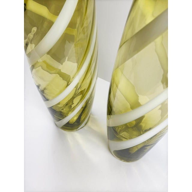 This pair of hand-blown chartreuse green glass vases was produced in Italy during the 1960s by Cristalleria Artistica...