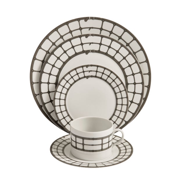 Crafted from fine porcelain, this set of four Aryan Dinner Plates draws inspiration from the refined tack and detailing of...
