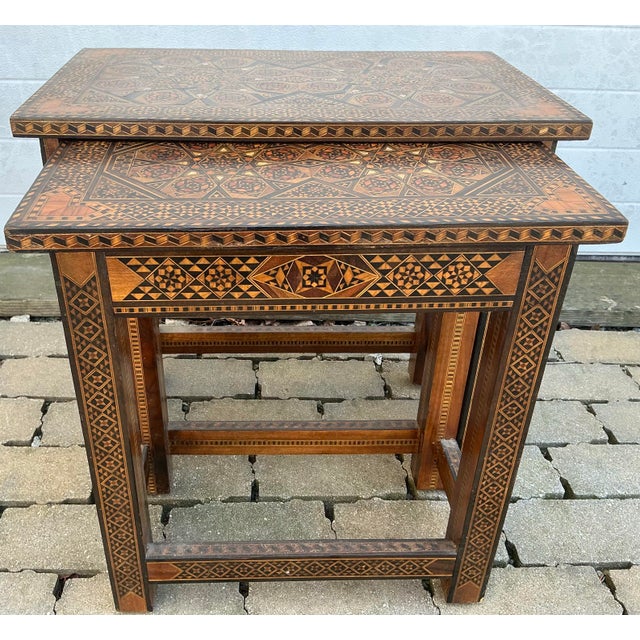 Wonderful pair of Moorish nesting tables from Syria. Intricately inlaid with mother-of-pearl and different types of wood....