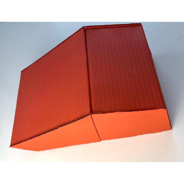 This one-of-a-kind piece is constructed with found cardboard and tomato red spray paint. It offers a 3D minimalist element...