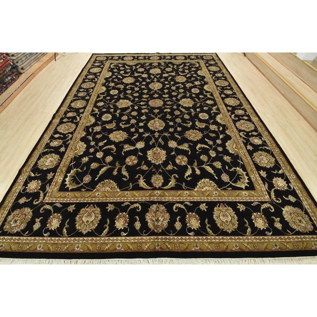 A traditional Agra rug is hand-knotted with a wool and silk pile on a cotton foundation. This finely woven oriental rug...