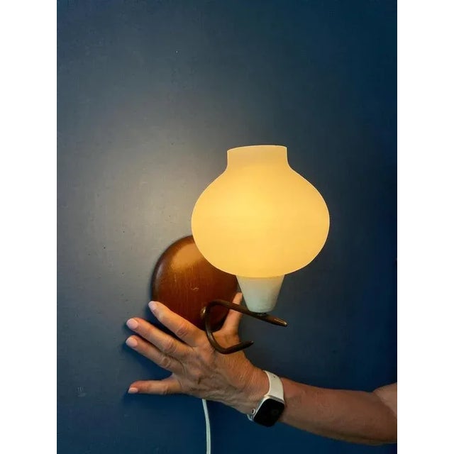 Vintage glass wall lamp with metal frame. The glass shade has a bubble like shape. The lamp requires one E14 lightbulb and...