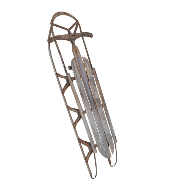 Vintage American snow sled used as wall decor in a vacation home. 53" L x 21" wide and 7" deep.