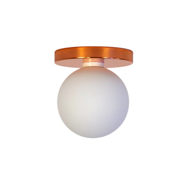 Minimal from top to bottom. This black flush mount pairs a metal base with a soft glass globe. Cool, calm, and quietly...