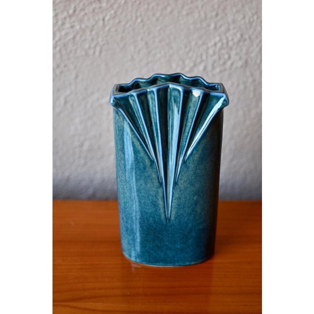 This elegant antique vase is both understated and precious. Made of Virebent porcelain with a mottled blue-green glaze, it...