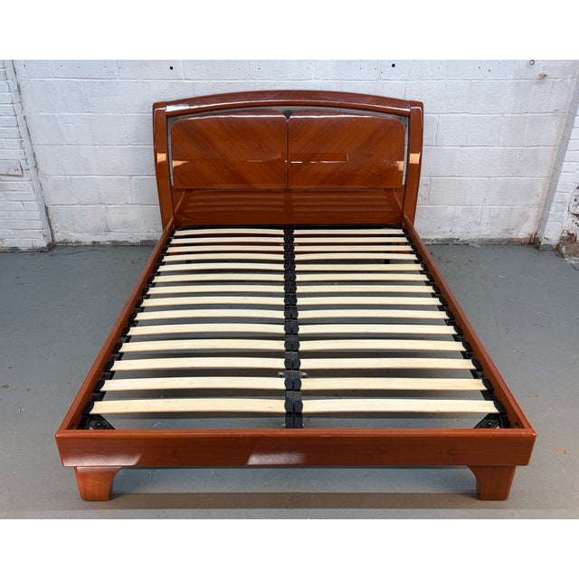 Transform your bedroom into a stylish retreat with this beautifully crafted modern platform bed in a rich lacquered cherry...