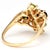 Green gemstones shimmer on this yellow gold ring as if they were olives attached to a tree branch. Diamonds add crisp...