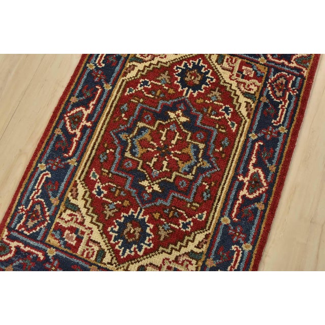 A traditional tribal Heriz rug hand-knotted with fine wool on a cotton foundation. This oriental rug features a central...