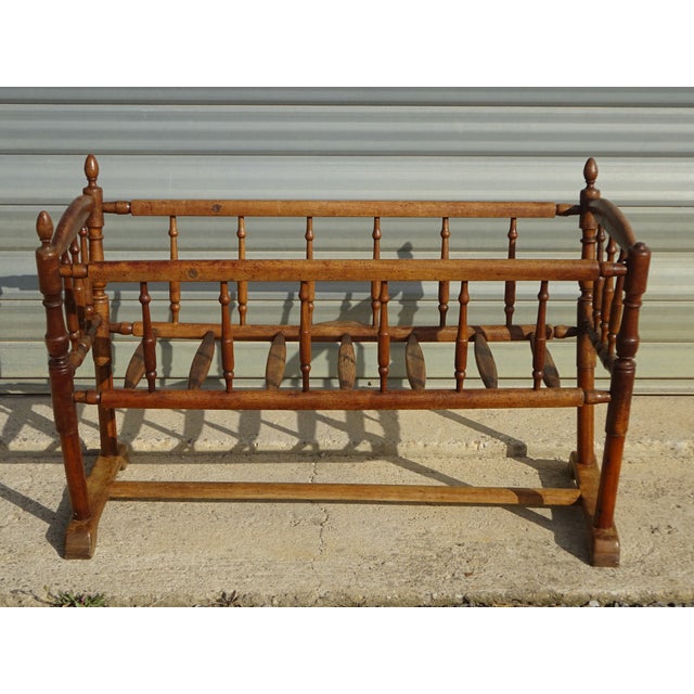 Cradle or small crib with bars, made entirely of solid walnut. The frame is composed of 18 turned wooden bars. 7 bars form...