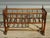 Cradle or small crib with bars, made entirely of solid walnut. The frame is composed of 18 turned wooden bars. 7 bars form...