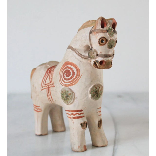 This is a Pucará horse, a traditional ceramic figurine from Peru. The "Caballo de Pucará" is a handmade figurine created...