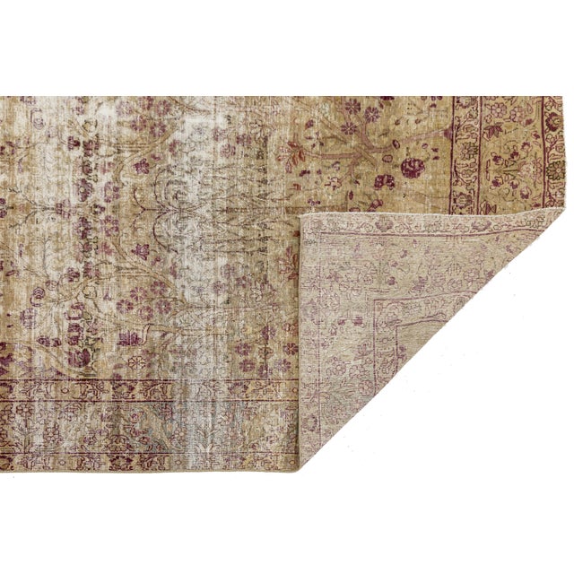 Exude timeless elegance with this captivating Antique Kerman Wool Rug. Characterized by its soft, golden-oatmeal ground...