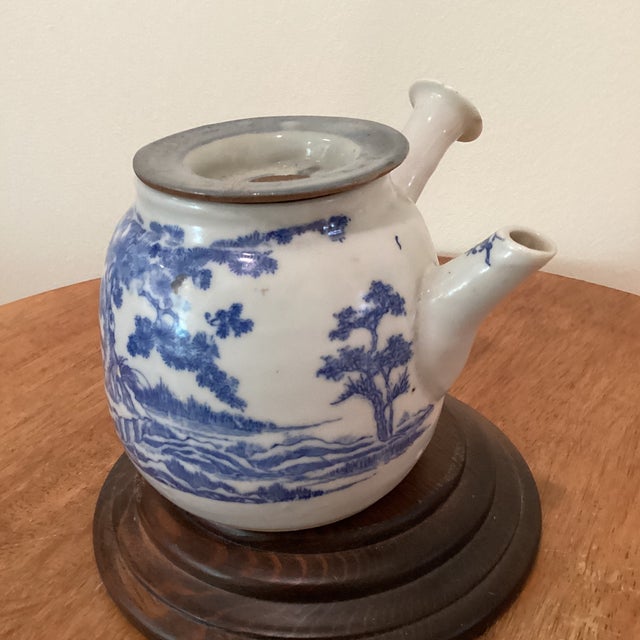 This Antique Japanese Kyushu Side-Handle Porcelain Teapot is a handmade piece showcasing a Shanshui scene and Chinese...