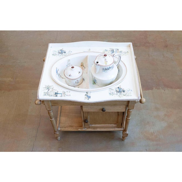A French miniature sink from the late 19th century, with pastoral scenes and and removable basin. Created in the Moselle...