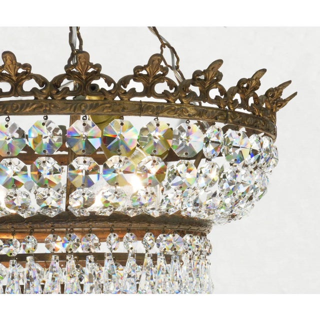 Beautiful tiered crown waterfall crystal chandelier from 1930s France. A myriad of multi-faceted octagonal and drop...