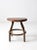 This is a vintage industrial stool. The short metal stool sloped seat with four legs and central stretcher.