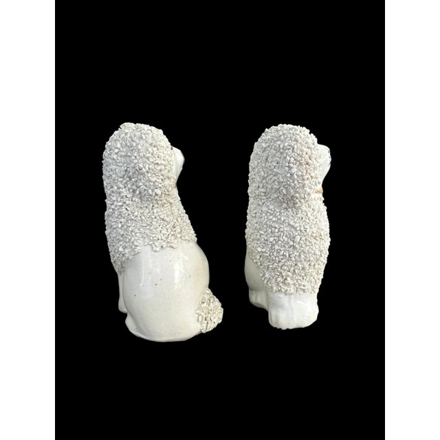 This charming pair of mid-20th-century English Staffordshire miniature poodle figurines dates to the late 1940s–1950s and...