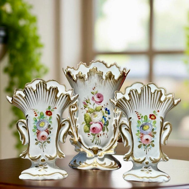 This set of three antique French vases is crafted from fine Old Paris porcelain, dating to the 19th century. The set...