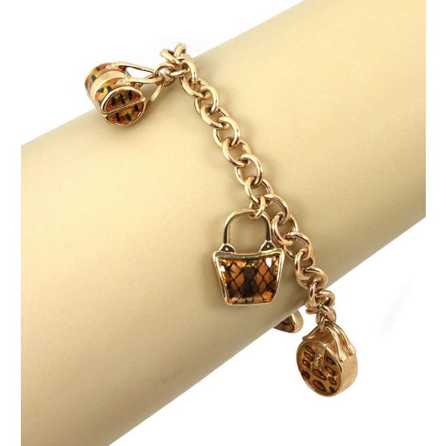 This beautiful charm bracelet is crafted from solid 14k yellow gold and features a polished, elegant finish. The design...