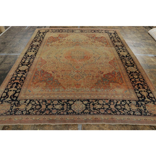 Hand knotted in wool originating circa 1890-1900, this 8x10 antique Persian rug connotes a regal Mohtashem rug...