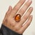 Classic vintage 14K yellow gold ring featuring a warm oval amber center, showcasing rich golden tones and natural...