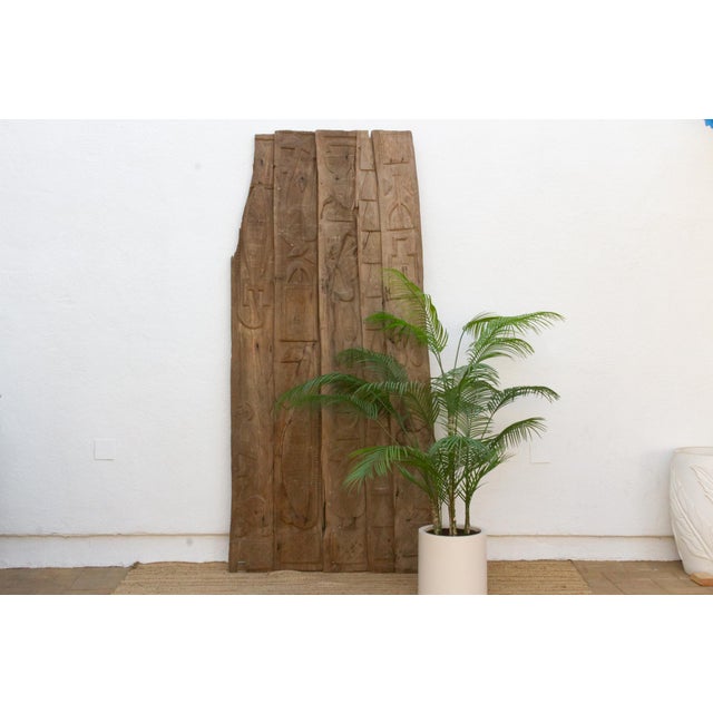 This 96-inch door, a full 8 feet tall, is a monumental five-plank Nupe piece from the Niger River basin of central...