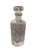A collected set of five vintage crystal liquor decanters, each featuring a distinctive silhouette, decorative pattern, and...