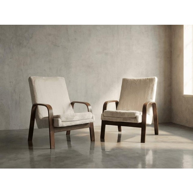 These 1970s French armchairs command attention through the masterful tension of opposing materials: the firm, sweeping...