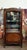 A marquetry display cabinet in fine woods, typical of the louis xv-louis xvi transition style. the front features an...