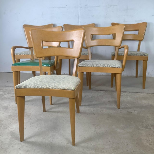 An iconic milestone in American mid-century design, this set of six vintage Heywood-Wakefield dining chairs beautifully...