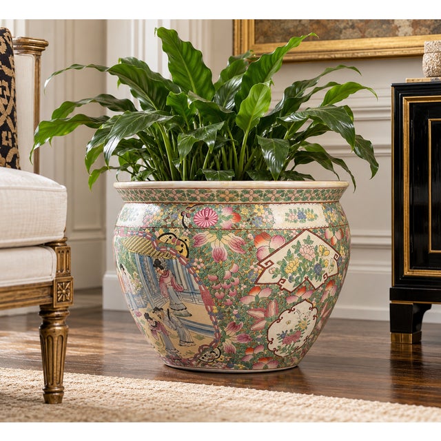 A beautifully decorated vintage Chinese porcelain fishbowl planter featuring an elaborate Famille Rose-style palette and...