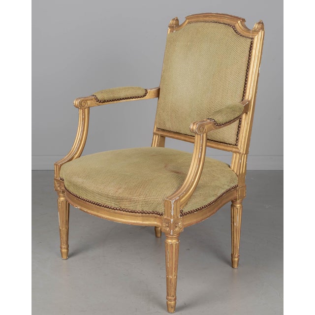 A Louis XVI style French fauteuil, or arm chair, with solid carved and gilded beech wood frame. Nice carved details....