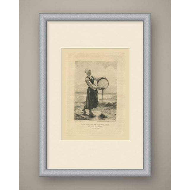 A young breton woman stands barefoot on a sheet spread over the ground at the edge of the sea, winnowing buckwheat. She...