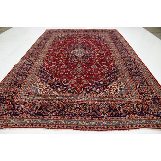 Elevate your space with this stunning, authentic vintage rug. Hand-knotted from high-quality, durable wool, it features a...