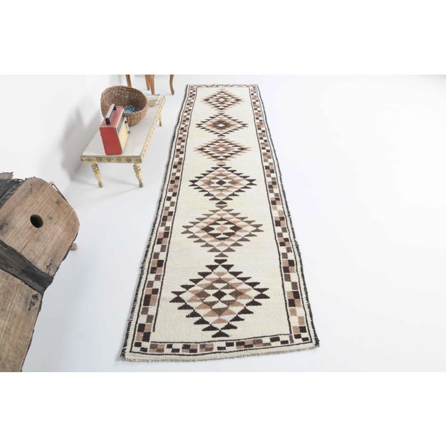 Vintage Turkish Hand-Knotted vintage rug is a semi-Vintage runner rug.'70s Eastern region of Turkey's unique rug is...