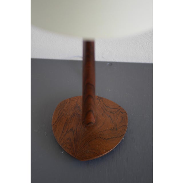 A rare and elegant vintage 1960s teak table lamp by eskilstuna armatur, sweden, exemplifying the timeless refinement of...