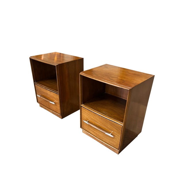 A pair of exquisite walnut nightstands or end tables designed by T.H. Robsjohn-Gibbings for Widdicomb in the 1950s. They...