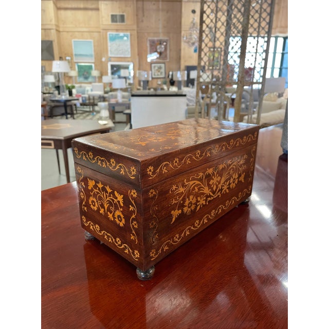 This vintage wooden tea caddy is exquisitely decorated with intricate floral marquetry inlay on all sides. The hinged lid...