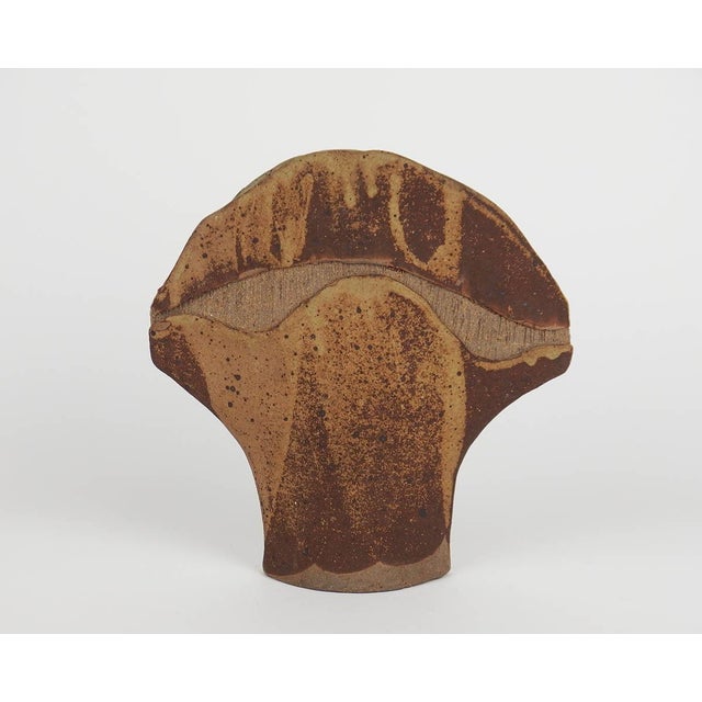 Organically shaped stoneware vase decorated with striations and an abstract brown and yellow design, signed Pichon...