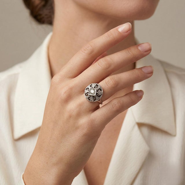 Elegant vintage 14K white gold ring featuring a natural diamond center totaling approximately 0.15 Carat Total Weight, set...