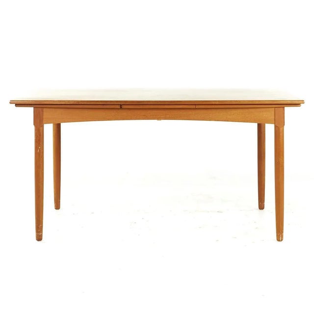Kurt Ostervig Style Mid Century Teak Hidden Leaf Dining Table This table measures: 60 wide x 39 deep x 29.25 high, with a...