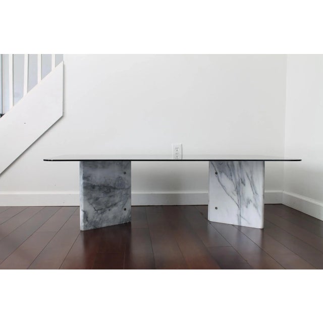 Beautiful Carrara marble coffee table from the 1970's. The design features two V shaped white marble stone bases which are...