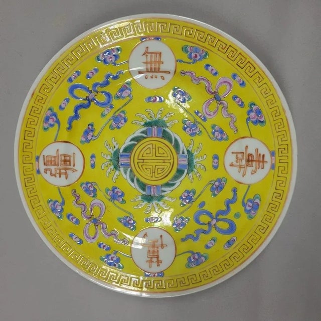 A brilliant yellow enameled porcelain 'Birthday' plate inscribed wan shou wu chiang (wishes for a long life without end)...